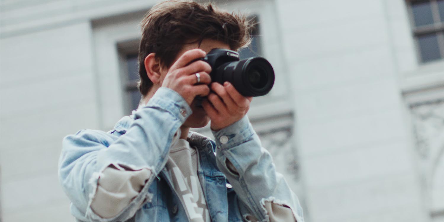 Person holdinga a camera lens