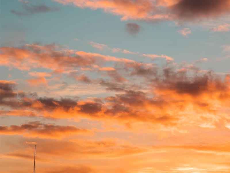 Person standing infront of vibrant sunsets