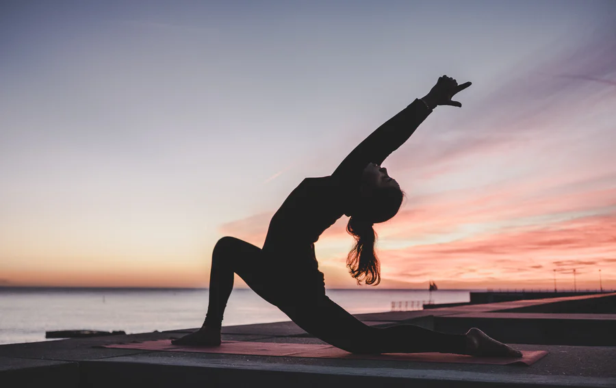 Person Stretching on Yoga Mat