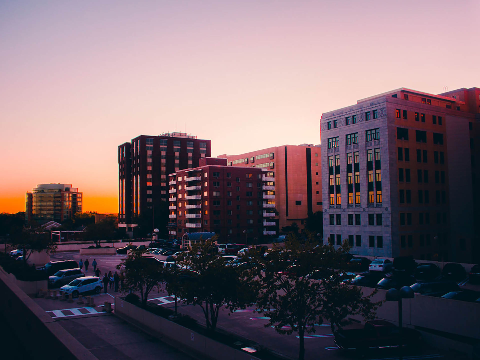 Rich, golden sunset rising among city architecture