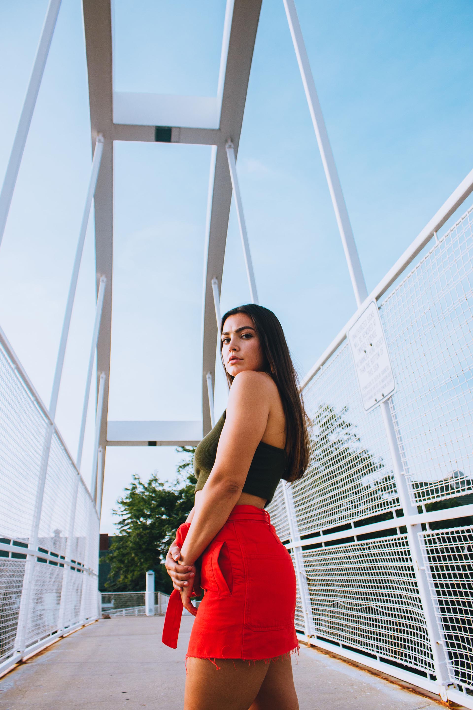 Model contrasts blue sky with red skirt
